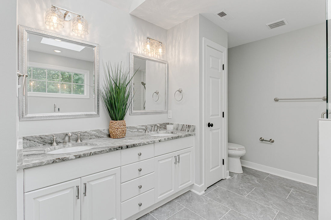 white bathroom with gray tile floors and white grout lines