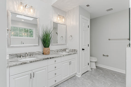 white bathroom with gray tile floors and white grout lines